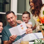 fathers-day-messages-dad-reading-greeting-card-with-kids