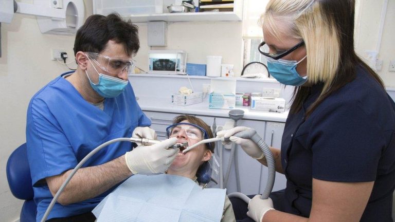_111652455_c0467269-dentist_and_dental_nurse_carrying_out_dental_treatment